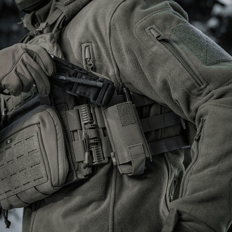M-Tac elastisk tourniquetficka Molle Gen.III monterad på taktisk väst, indikerar snabb åtkomst och säker förvaring av tourniquet.