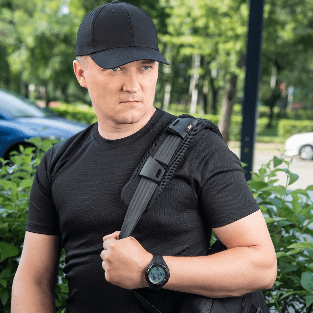 Mand bærer en rygsæk med M‑Tac Skulderremspude 50 mm Elite for komfort og vægtfordeling.