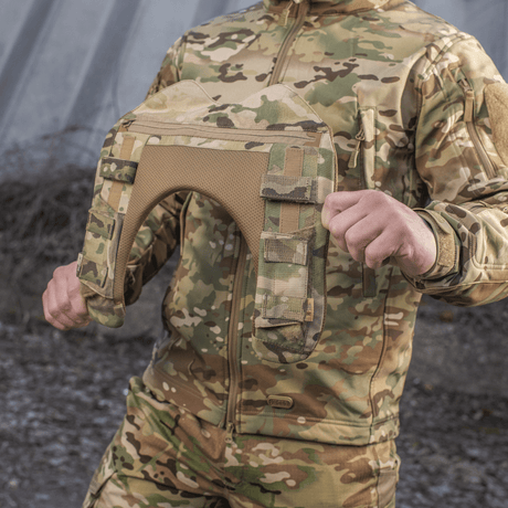 Person med M-Tac axelkudde till Plate Carrier Cuirass QRS i camouflagemönster, designad för komfort och viktfördelning.