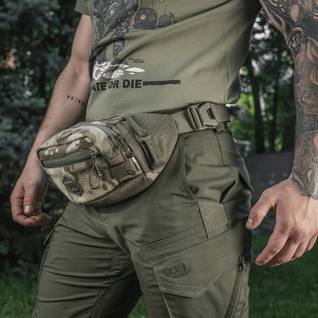 M‑Tac bältesväska Elite Hex i camouflage, slitstarkt Cordura-material, på person i grön outdoor-klädsel.