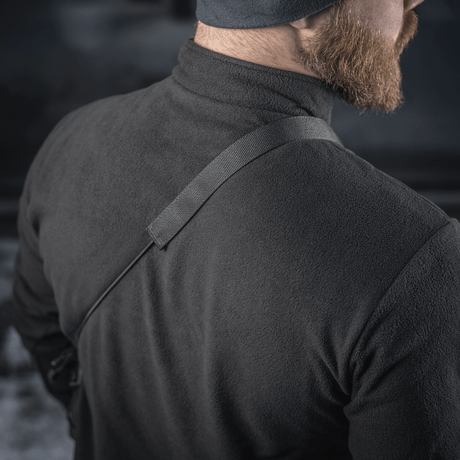 M-Tac Pocket Bag Elite HEX bæres over skulderen på en mand i sort jakke, viser remens robusthed og bærekomfort.