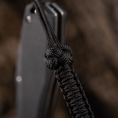 M-Tac Knife Lanyard Celtic, en flätad paracord-lanyard i svart som framhäver knivens design och praktiska funktion.
