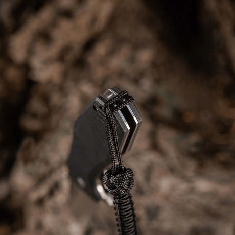 M-Tac Knife Lanyard Celtic - svart flätad paracord-lanyard på en kniv, tillför stil och funktionalitet till knivar, ficklampor och utrustning.
