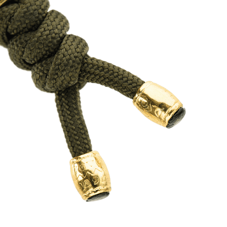 M-Tac Zeus Lanyard i flätad paracord med stilfull design och gyllene ändar, perfekt för förvaring av kniv och utrustning.