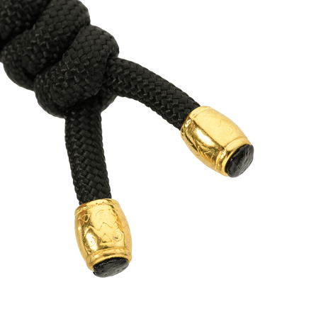 M-Tac Zeus Lanyard i flätad paracord, svart med gyllene ändar, stilfullt och praktiskt knivtillbehör.