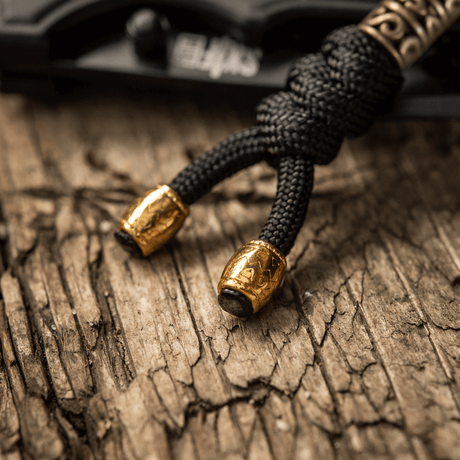 M-Tac Zeus Lanyard i flätad paracord-design, dekorativt och praktiskt tillbehör med gyllene detaljer, idealisk för kniv och utrustning.