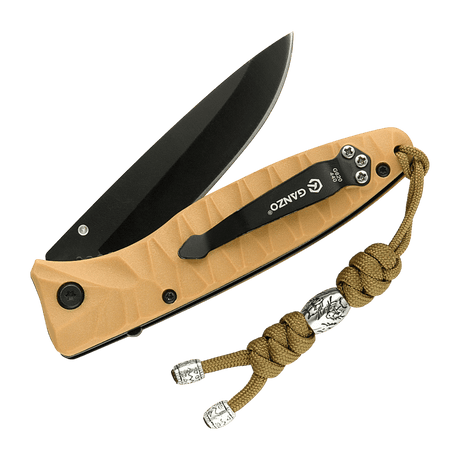 M-Tac Zeus Stainless Steel Lanyard på en kniv, flätad paracord med dekorativ stålpärla, praktisk för snabb åtkomst till utrustning.