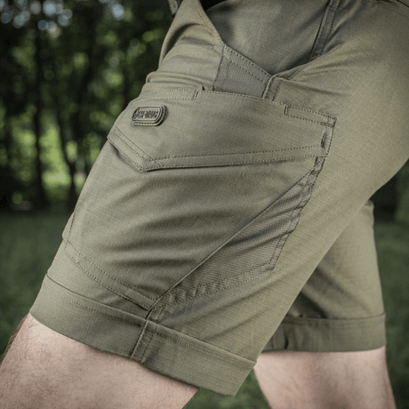 M-Tac Shorts Aggressor Short i grøn med taktiske funktioner og lomme, ideel til udendørs brug og komfortabel bevægelse.