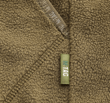 Detalje af M-Tac Lite Microfleece Hættetrøje med mesh-struktur og elastisk kantbånd, ideel til komfort og bevægelsesfrihed.