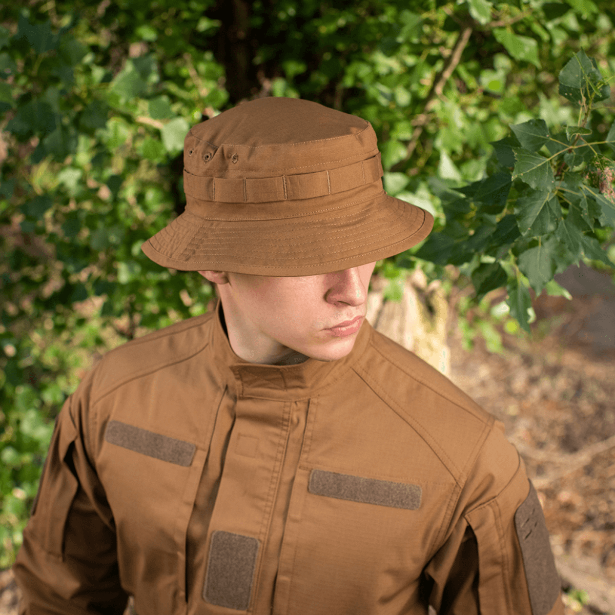 Person wearing M-Tac Panama Rip-Stop hat with camouflage gear