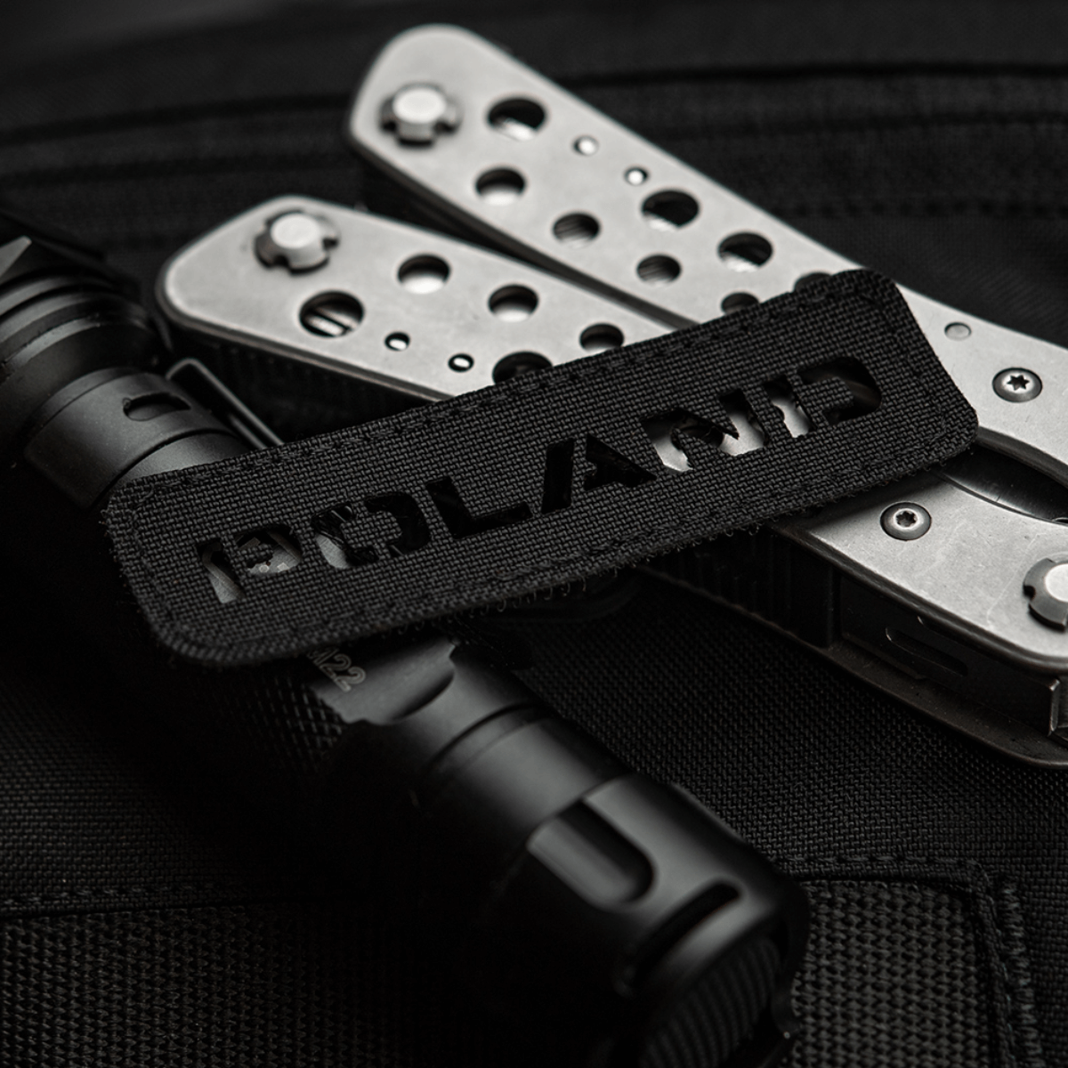 M‑Tac Patch Poland End-to-End 25x80 perforeret Cordura 500D patch med laser cut design, fastgjort til udstyr med velcro.