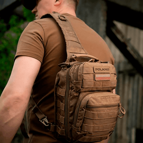 Man med ryggsäck utrustad med M‑Tac Patch Poland End-to-End 25x80 i hållbart Cordura-material, fäst med velcro.