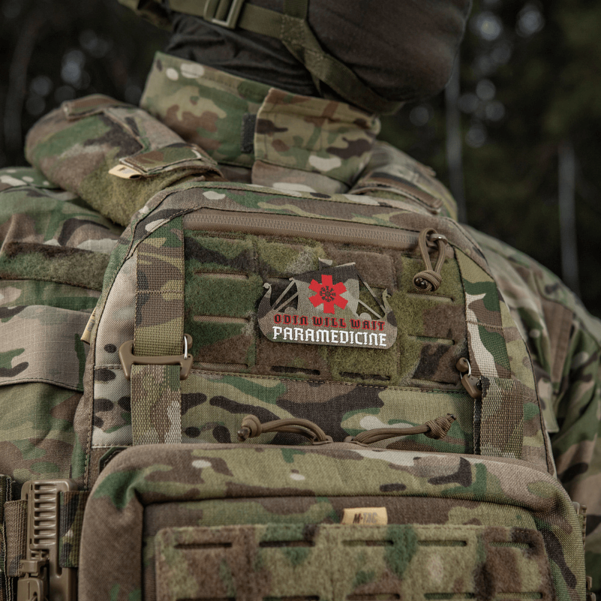 Camouflage uniform with paramedic patch displaying "Odin will wait Paramedicine" emblem