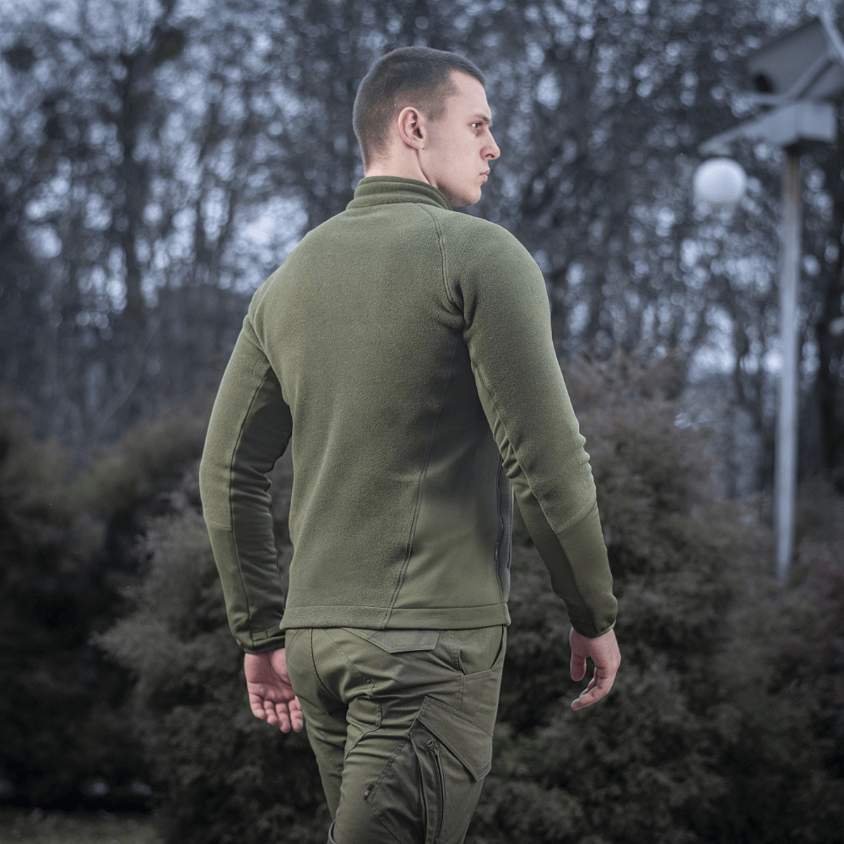 Mand iført M-Tac Polartec Sport Fleecejakke i naturlige omgivelser om vinteren, fremhævet for varmeisolering og komfort.