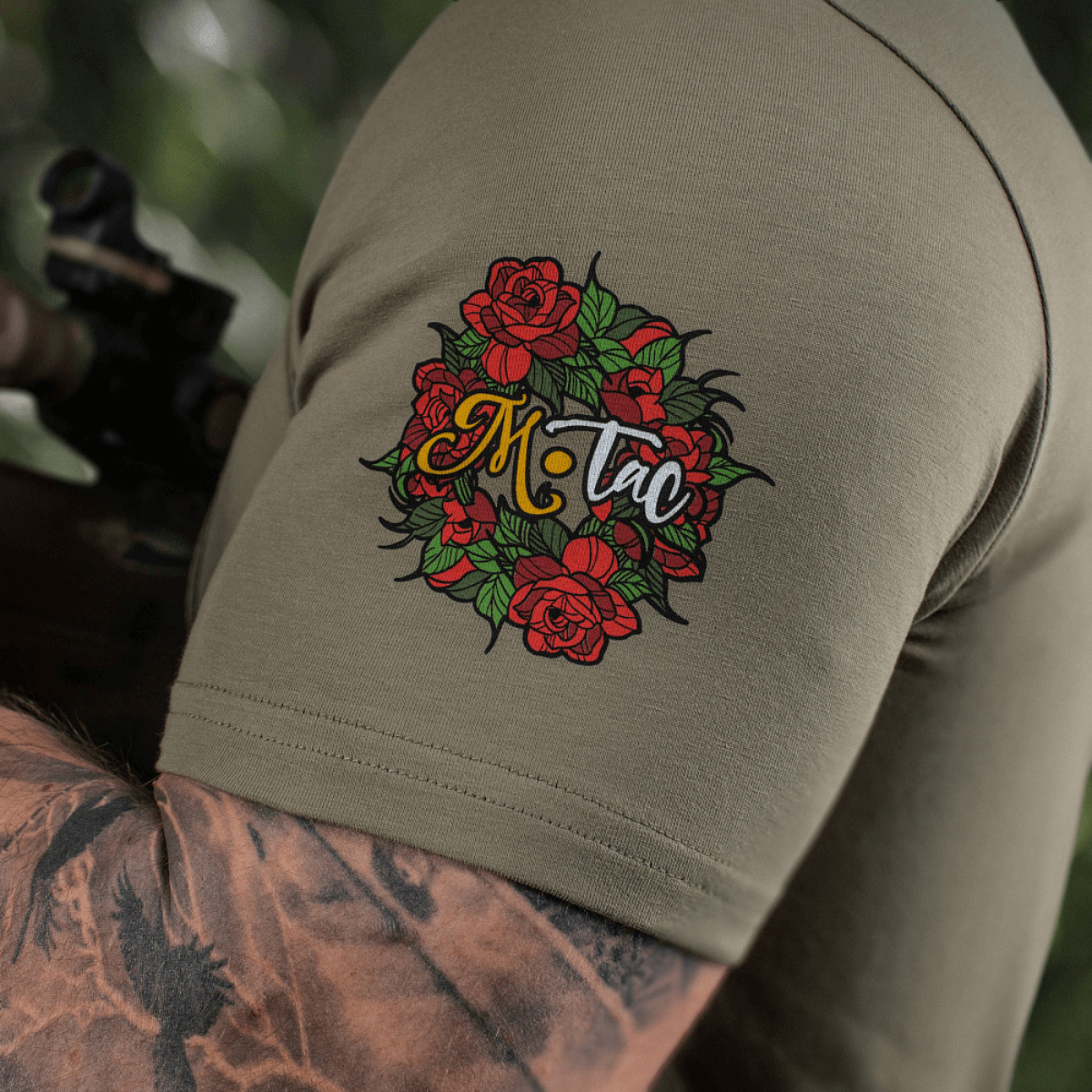 M-Tac T-Shirt Motanka med blomsterdesign på ærmet, fremhæver ukrainsk kulturarv og moderne stil i olivengrøn.