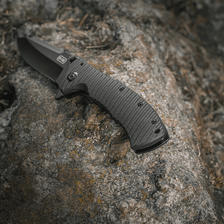 M-Tac Outdoor & Militär fällkniv - Type 7 på sten, lättviktsdesign, svart blad i kromat rostfritt stål, frame-lock-mekanism.
