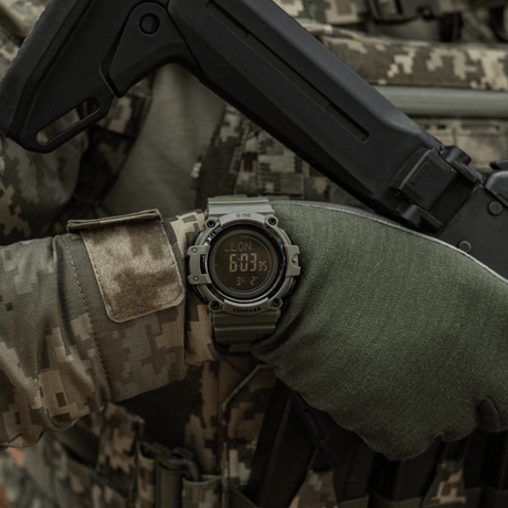 M-Tac Tactical Ur med Kompas 2233 på en taktisk utomhusbakgrund.