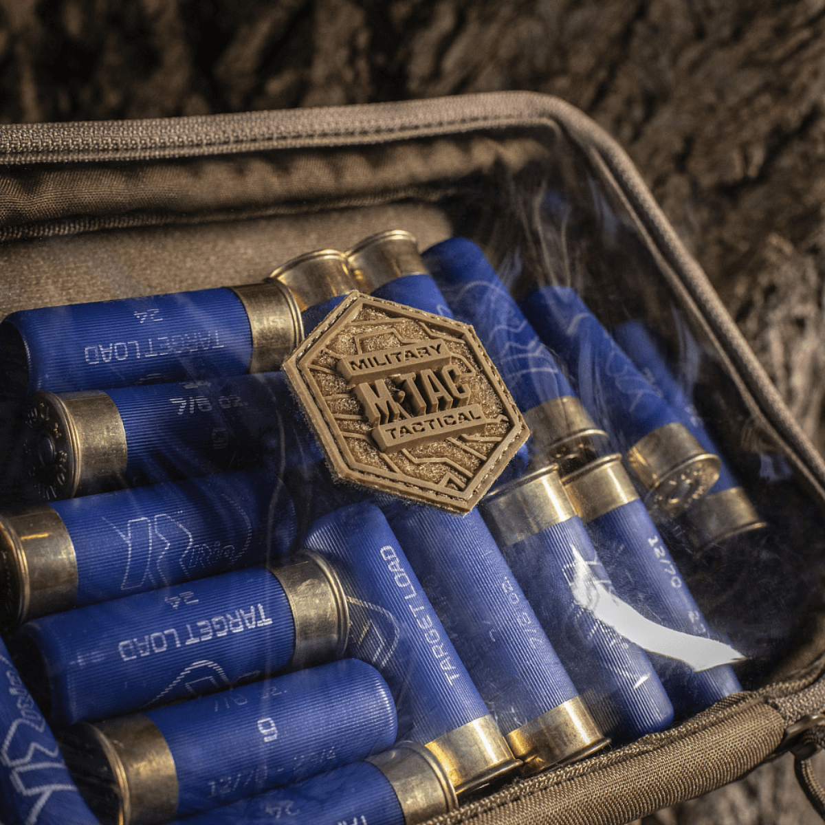 M-Tac Utility Organizer Slim Elite med gennemsigtig forvæg, opbevarer blå patronhylstre sikkert og organiseret i naturmiljø.