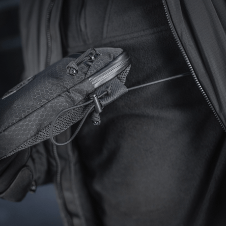Person holding M-Tac Pocket Bag Elite HEX with durable YKK zipper in close-up view.