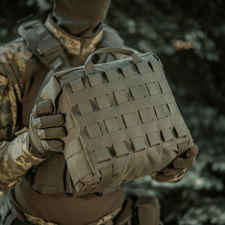 Person holding M-Tac Pouch Sukharka Gen.3 XL in camouflage clothing, showcasing MOLLE system and durability.