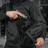 Person demonstrating quick access to concealed weapon in M-Tac Tablet Bag Laser Cut Hex, highlighting tactical functionality.