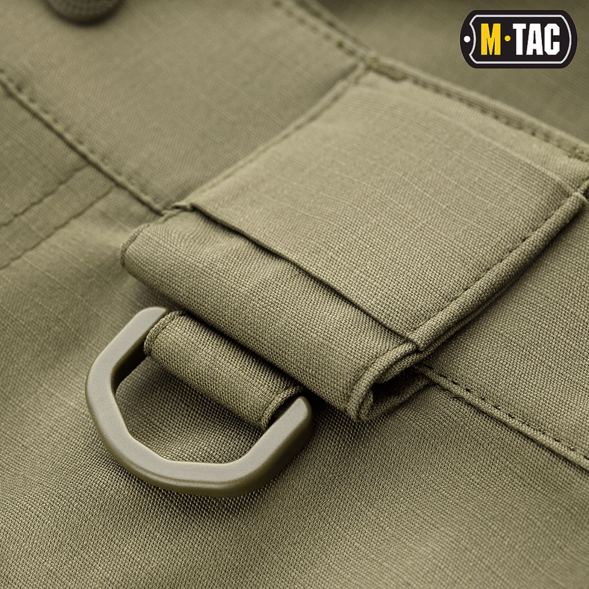 Detalje af M-Tac Shorts Aggressor Short med D-ring i olivengrøn rip-stop stof til taktisk udstyrsfiksering.