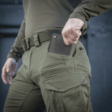 M-Tac Bukser Patriot Gen.III Vintage i brug til udendørs aktiviteter, grønne taktiske bukser med lommer, robust og alsidig beklædning
