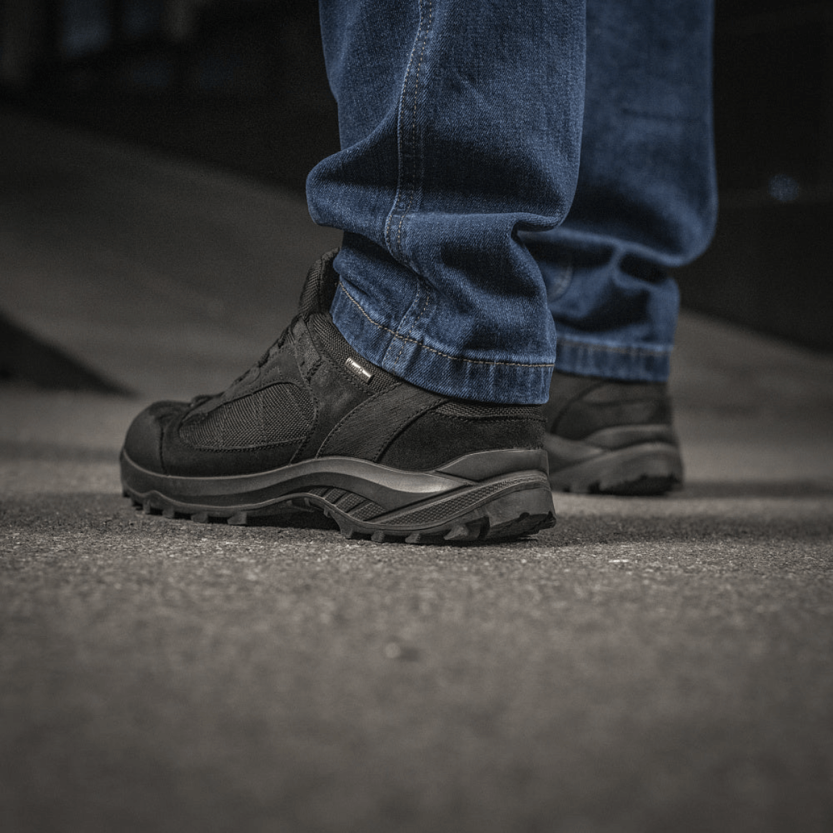 Person wearing M-Tac Jeans Aggressor showcasing durable denim and tactical functionality, perfect for outdoor activities.