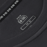 Close-up of M-Tac T-shirt 93/7 Summer label showing size XS, emphasizing high-quality materials for comfort and fit in everyday use.