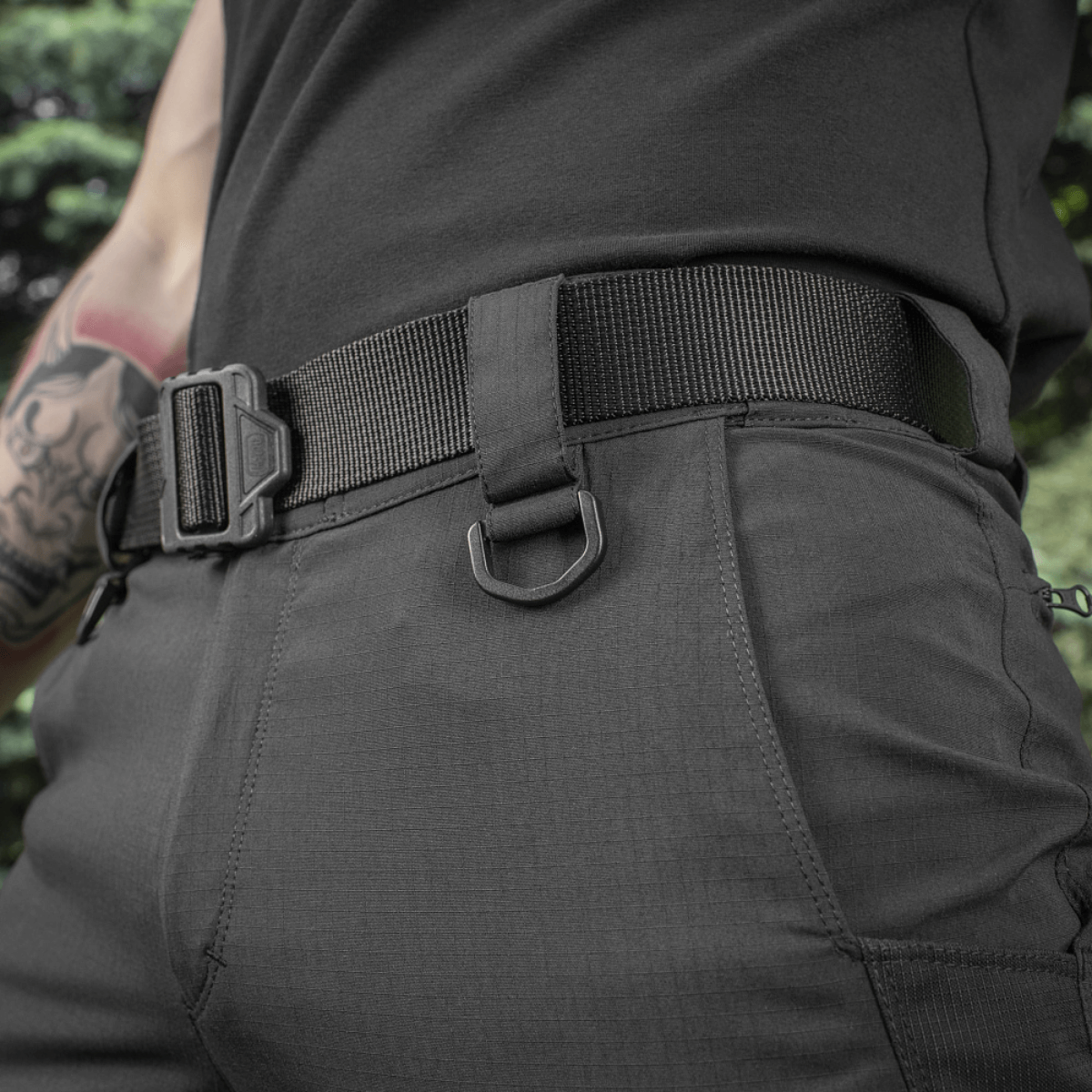 Person wearing M-Tac Aggressor Summer Flex Shorts with elastic tunnel waist and D-ring details, ideal for tactical use.