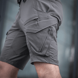 M-Tac Aggressor Summer Flex Shorts i grå, letvægts-taktiske shorts til træning og udendørs aktiviteter, visning af flere lommer.