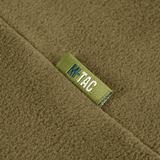 Nærbillede af M-Tac Delta Polartec Pullover Dame i olivengrøn farve med mærkelabel.