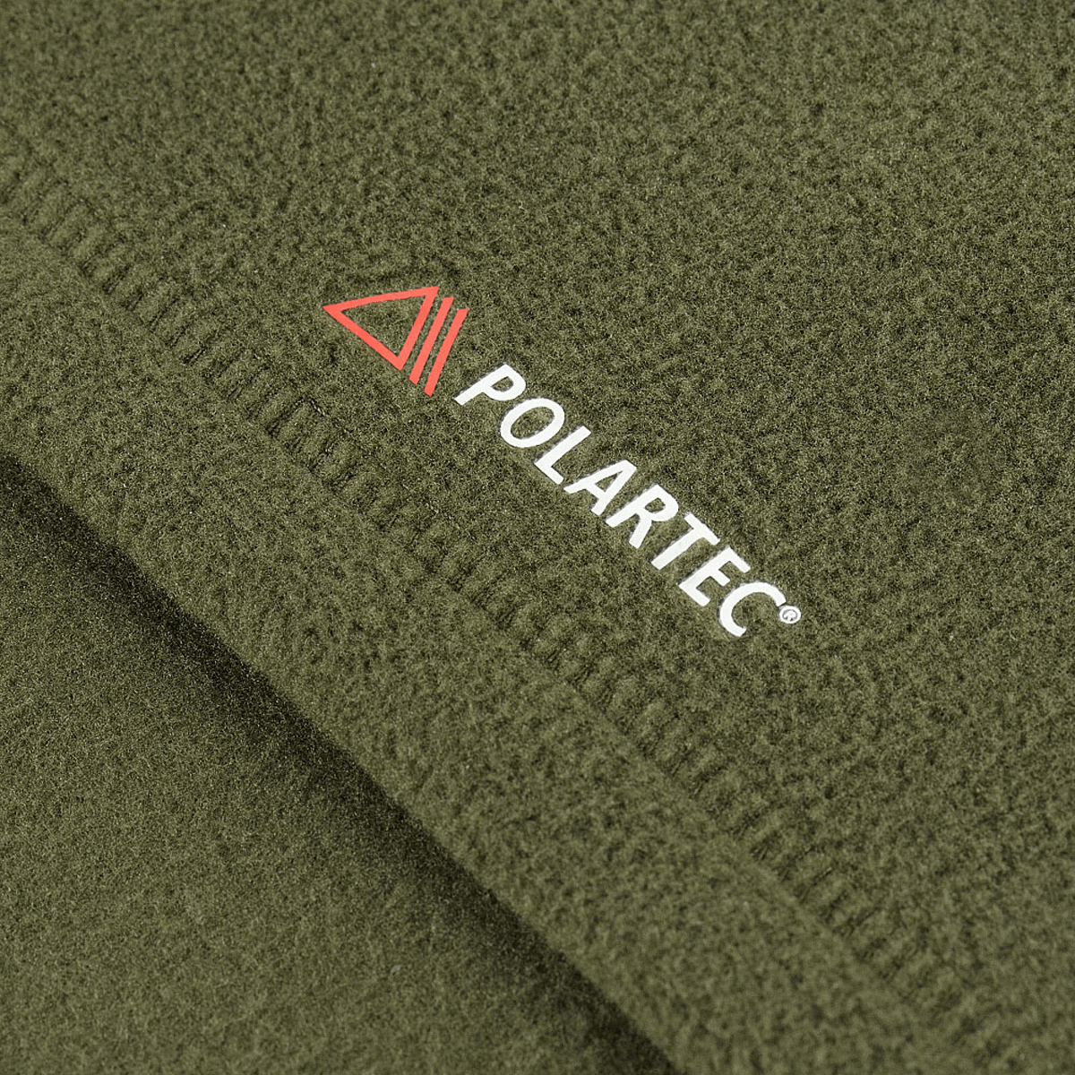 Nærbillede af M-Tac Delta Polartec Fleecejakke Dame med Polartec® logo på grønt fleecestof.