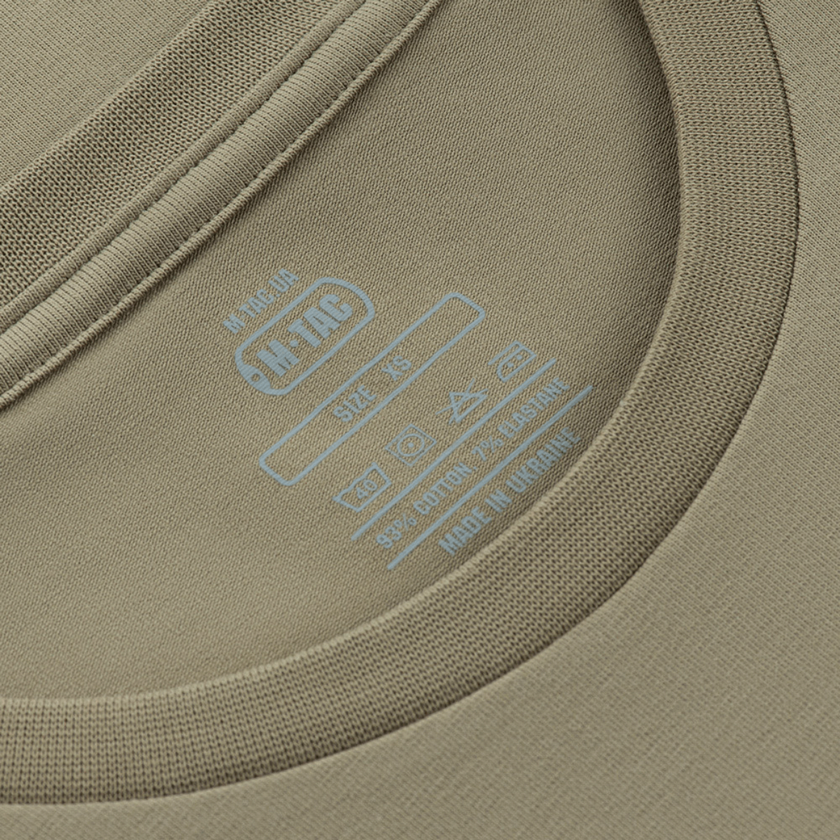 M-Tac T-Shirt Rex Team label med blå mærkning, der viser detaljerne om størrelse og materiale på kraven.