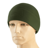 M-Tac Watch Cap Elite Fleece Beanie Hat Velcro i grøn, let og varm hue til taktisk brug med velcro-panel til mærker, bæres på mannequin.