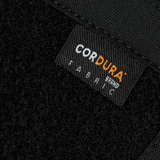 Nærbillede af Cordura stofmærke på M-Tac Sphaera Hardsling Bag Large Elite med Velcro, fremstillet af holdbare materialer.